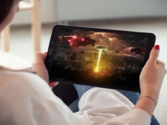 Person watching a sci-fi invasion movie on a tablet.