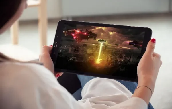 Immersive Streaming Entertainment Person watching a sci-fi invasion movie on a tablet.