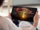 Person watching a sci-fi invasion movie on a tablet.
