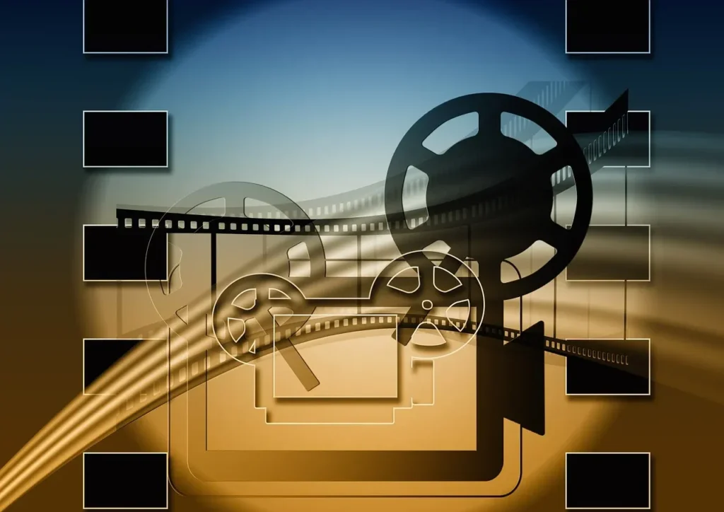 An abstract digital illustration featuring several overlapping film reels and film strips with perforations, rendered in shades of black and white, against a gradient background transitioning from blue at the top to orange and brown at the bottom. Several black rectangular frames are positioned around the edges, suggesting individual movie screens or frames.