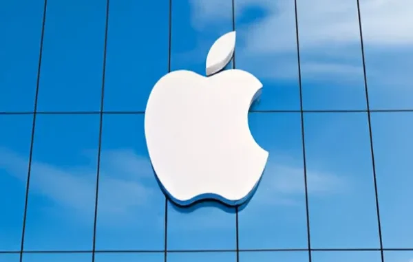 The Apple Icon: A Symbol of Innovation and Market Anticipation The iconic white Apple logo prominently displayed on the exterior of a modern glass building, reflecting a blue sky.