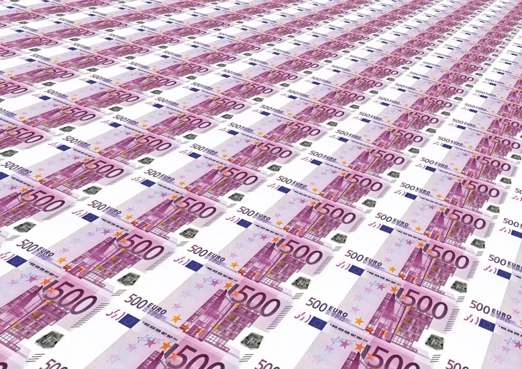A multitude of purple 500 Euro banknotes arranged in a grid, emphasizing a large sum of European currency.