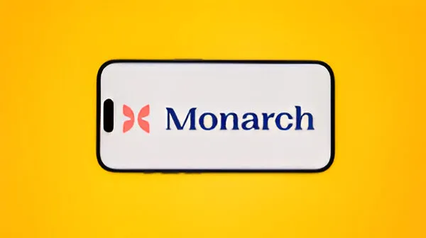A close-up of a mobile phone screen displaying the Monarch Money app's dashboard, showing a net worth graph, account balances, and recent transactions.